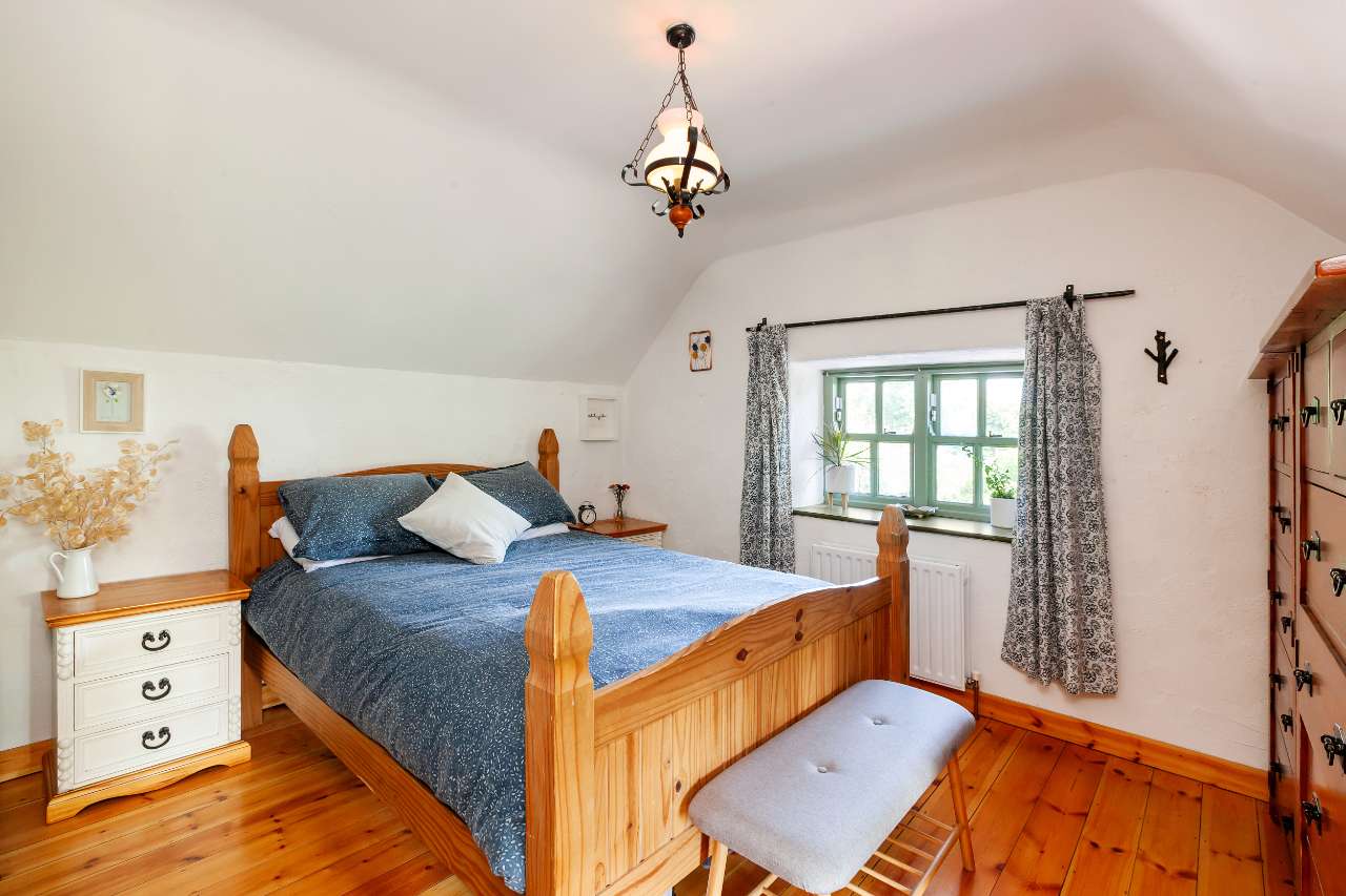 Main bedroom under the sloping thatched ceiling