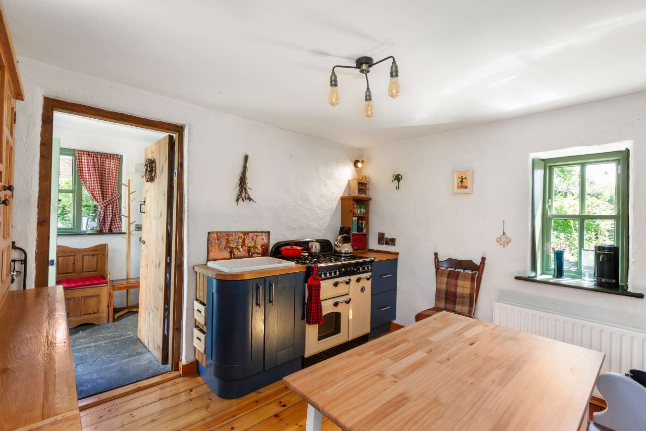Country kitchen with cream range cooker and Belfast sink